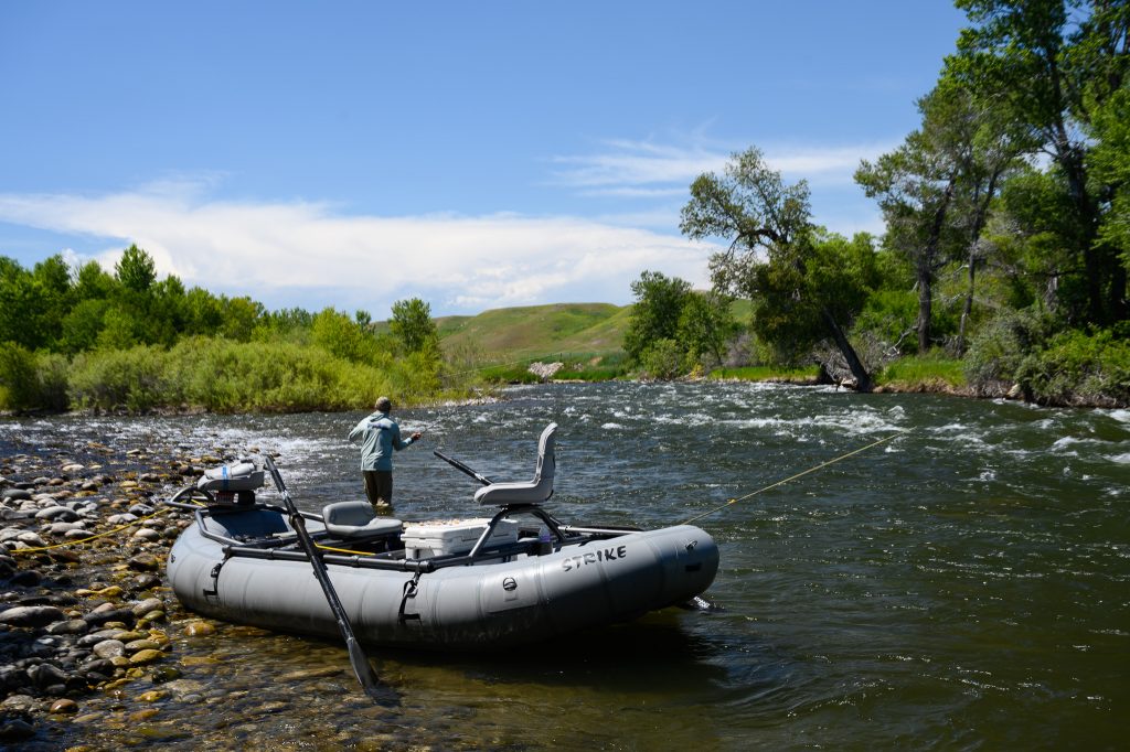 Angler fly fishing in Montana during the summer