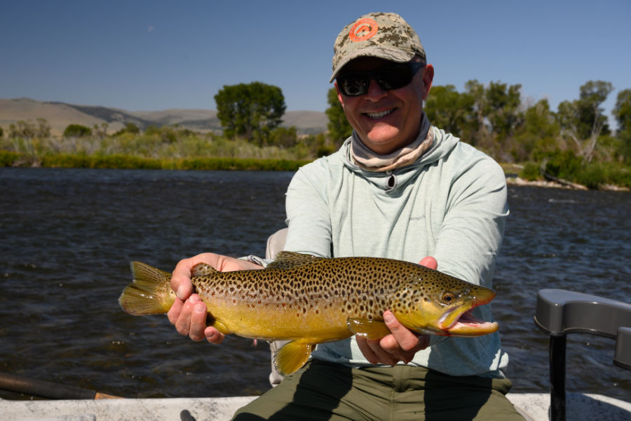 Angler with brown trout on Madison River