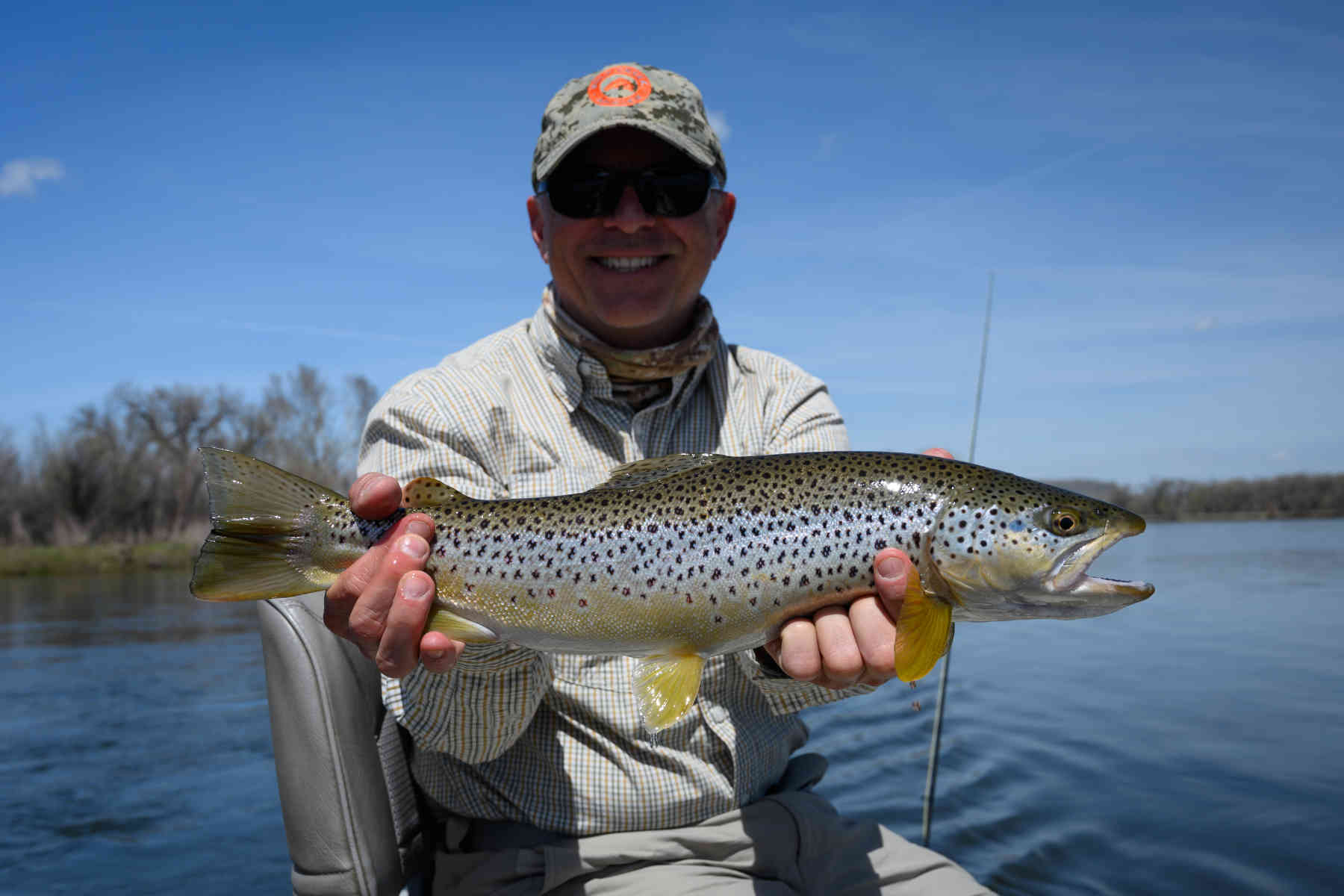 Angler holding a Missouri River brown trout in Montana
