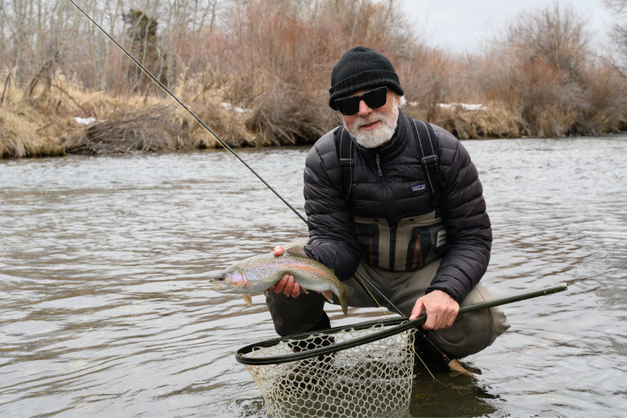 angler with a rainbow trout on DePuy's Spring Creek in Montana