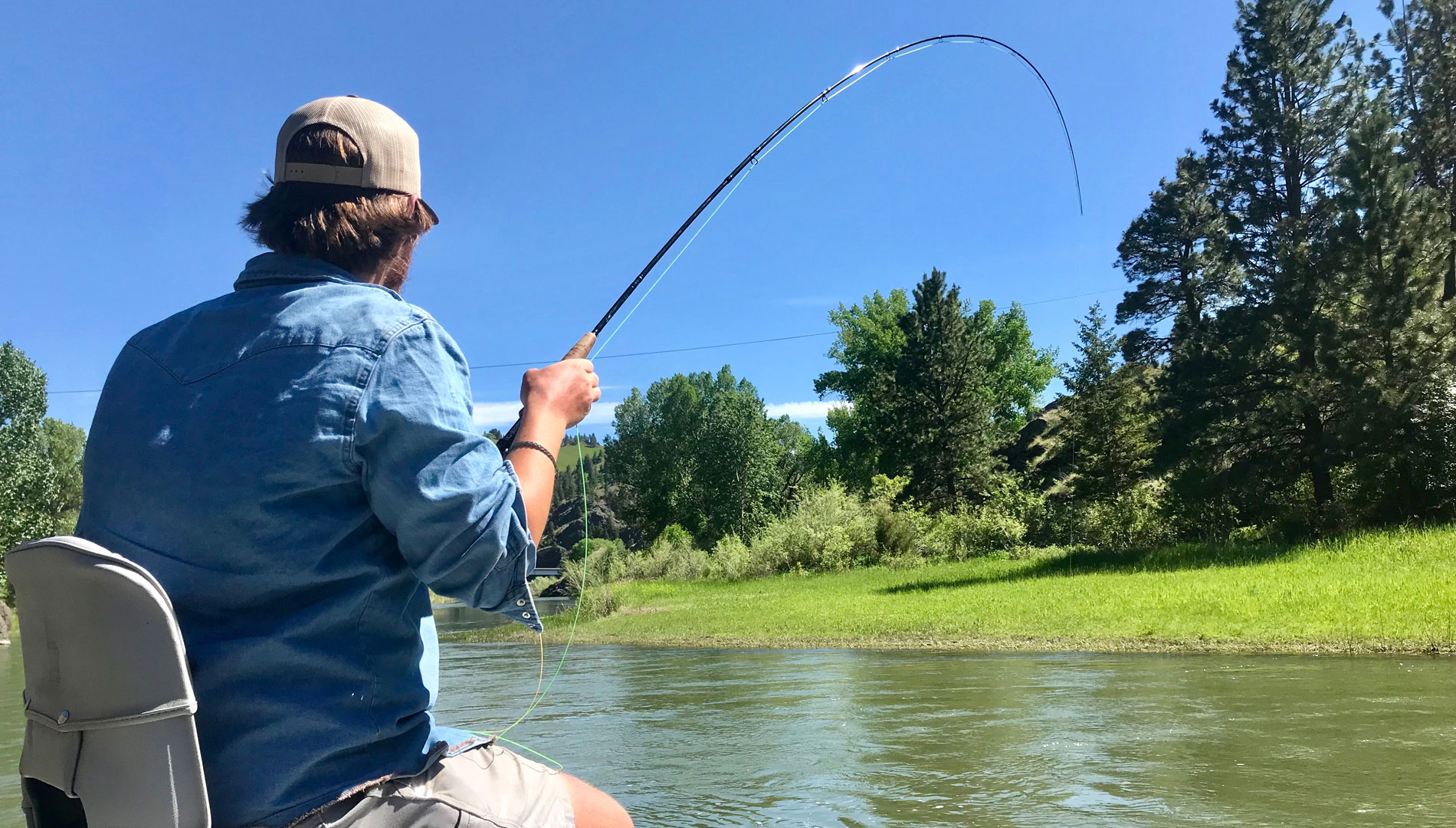 fly fisher on drift boat on dearborn river