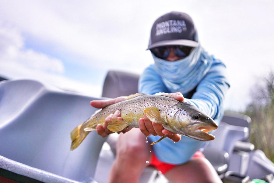 Angler holding a brown trout in Montana