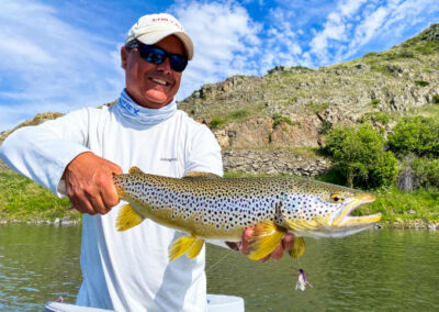 Angler with a brown trout on Montana's Missouri River