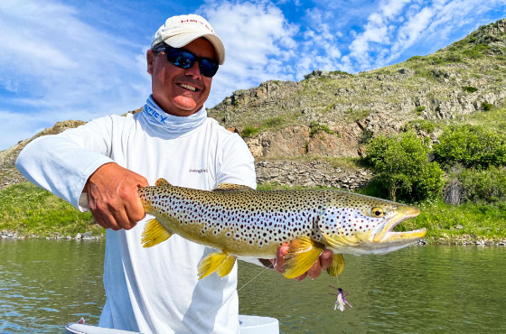 Angler with a brown trout on Montana's Missouri River