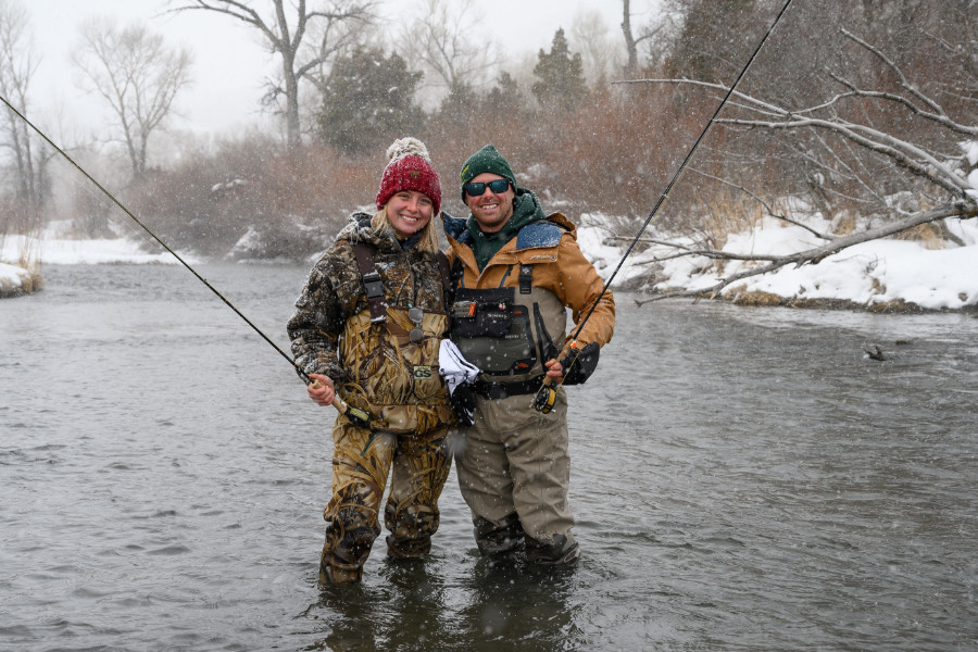 Angler couple enjoying winter fly fishing