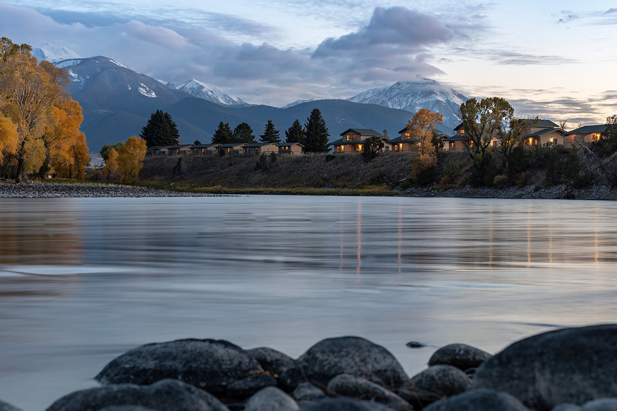 yellowstone valley lodge with river in the foreground and mountains in back